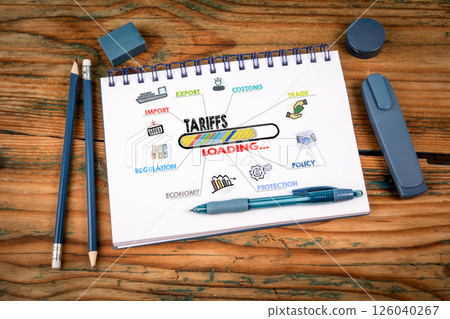 Tariffs Loading Concept. Notepad on a wooden texture background Tariffs Loading Concept. Notepad on a wooden texture background 126040267