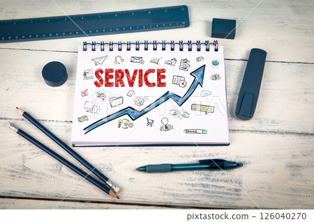 Service Concept. Notepad and blue stationery on a white wooden texture background Service Concept. Notepad and blue stationery on a white wooden texture background 126040270