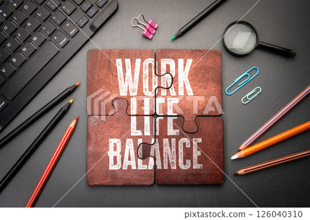 Work Life Balance Concept with Puzzle Pieces, Office Supplies, and Keyboard Work Life Balance Concept with Puzzle Pieces, Office Supplies, and Keyboard 126040310