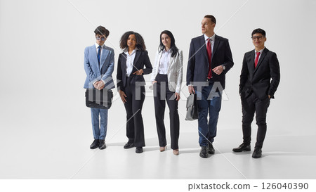 Group portrait of young, confident people dressed formal suits posing together against white studio background. Group portrait of young, confident people dressed formal suits posing together against white studio background. 126040390