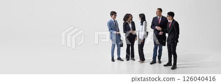 Banner. Group of young people, dressed formal suits discussing against white studio background with negative space. 126040416