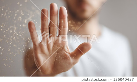 Raised hand signaling stop against floating particles. Symbol of allergy defense, pollen season, air protection, and health awareness during respiratory sensitivity. Raised hand signaling stop against floating particles. Symbol of allergy defense, pollen season, air protection, and health awareness during respiratory sensitivity. 126040457