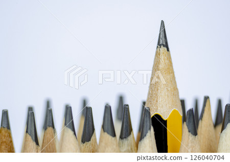 A pencil standing out from the rest representing Courage or Leadership with customizable space for text A pencil standing out from the rest representing Courage or Leadership with customizable space for text 126040704