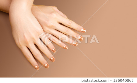Beautiful Female Hands with bright orange Manicure like Candy Corn. Manicured Nails with Yellow Gel Polish. Halloween Style Beautiful Female Hands with bright orange Manicure like Candy Corn. Manicured Nails with Yellow Gel Polish. Halloween Style 126040865