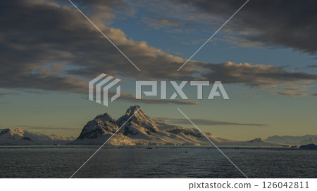 Awe inspiring polar landscape with calm waters, glaciers, mountains and sunrise, Antarctica Awe inspiring polar landscape with calm waters, glaciers, mountains and sunrise, Antarctica 126042811