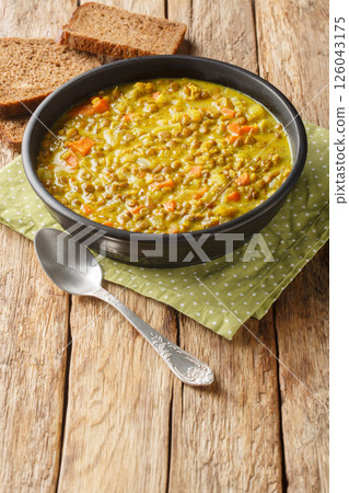 Detox lentils Soup contains anti-inflammatory ingredients like turmeric, lemon, and ginger closeup in the plate. Vertical Detox lentils Soup contains anti-inflammatory ingredients like turmeric, lemon, and ginger closeup in the plate. Vertical 126043175