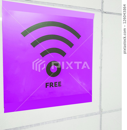 Free Wi-Fi zone symbol, purple sign on a white wall in a public empty space Free Wi-Fi zone symbol, purple sign on a white wall in a public empty space 126043864