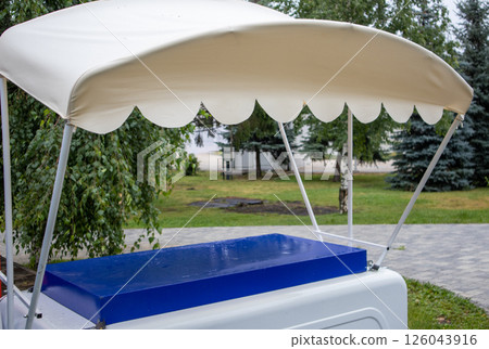 A street vending tent, a mobile tray with a retro-style awning A street vending tent, a mobile tray with a retro-style awning 126043916