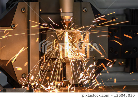 Close up scene the fiber laser cutting machine cut the square shape stainless steel tube with sparkling light. 126045030