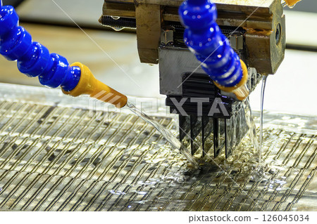 The EDM machine working with graphite electrode. The EDM machine working with graphite electrode. 126045034
