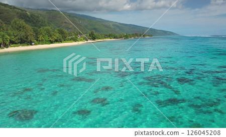 Breathtaking aerial view of Huahine in French Polynesia, highlighting the lush greenery, white sandy beaches, and crystal-clear turquoise waters of a tropical paradise 126045208