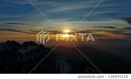 Rocky snow mountains at sunset aerial 126045310