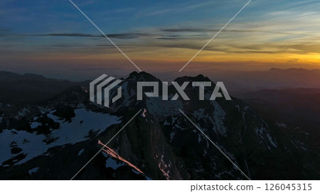 Rocky snow mountains at sunset aerial Rocky snow mountains at sunset aerial 126045315