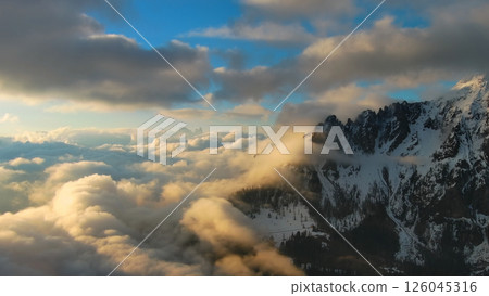 Rocky mountains in clouds at sunset aerial Rocky mountains in clouds at sunset aerial 126045316