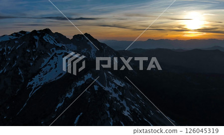 Rocky snow mountains at sunset aerial Rocky snow mountains at sunset aerial 126045319