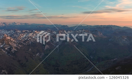 Rocky snow mountains at sunset aerial Rocky snow mountains at sunset aerial 126045326