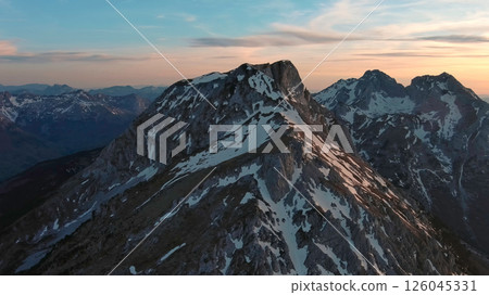 Rocky snow mountains at sunset aerial Rocky snow mountains at sunset aerial 126045331