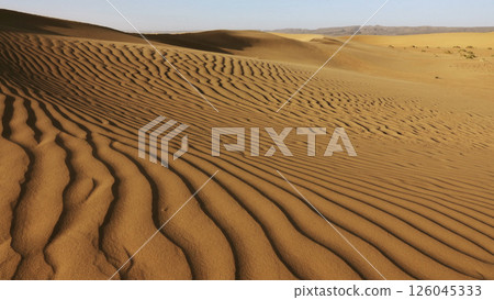 Sand blowing over sand dunes in wind 126045333