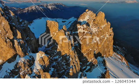 Rocky snow mountains at sunrise aerial Rocky snow mountains at sunrise aerial 126045344