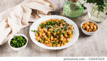 Warm salad of white fried beans and parsley on a plate on the table web banner Warm salad of white fried beans and parsley on a plate on the table web banner 126045829