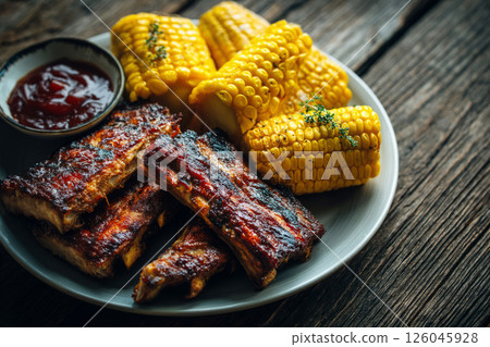Grilled pork ribs with barbecue sauce and corn 126045928
