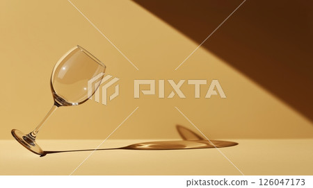 Elegant wine glass casting intriguing shadows on a textured surface 126047173