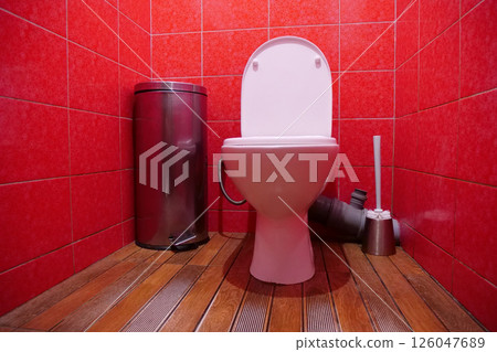 Toilet room interior with toilet bowl, wastebasket, toilet brush and red tiles Toilet room interior with toilet bowl, wastebasket, toilet brush and red tiles 126047689