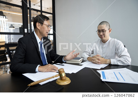 coworker or client is listening to a lawyer or judge explaining 126047862