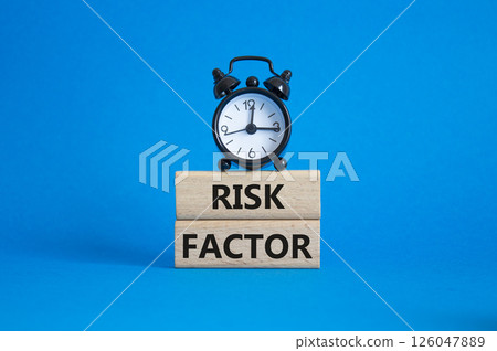 Risk Factor symbol. Wooden blocks with words Risk Factor Beautiful blue background with alarm clock. Business and Risk Factor concept. Copy space. 126047889