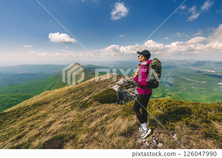 Young Woman with Backpack Traveling in Mountains 126047990