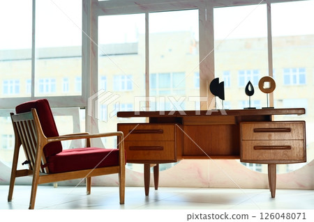 A stylish MidCentury Modern Workspace with a beautifully designed Wooden Desk and Chair 126048071