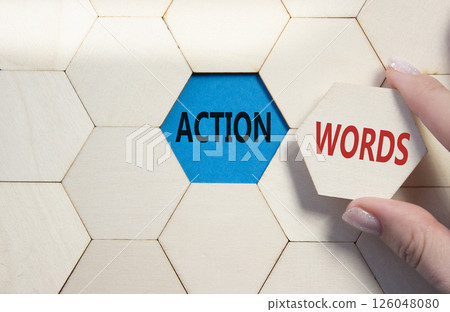 Action or words symbol. Concept word Action or words on wooden comb puzzle. Businessman hand. Beautiful blue background. Business and Action or words concept. Copy space 126048080