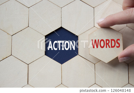 Action or words symbol. Concept word Action or words on wooden comb puzzle. Businessman hand. Beautiful deep blue background. Business and Action or words concept. Copy space Action or words symbol. Concept word Action or words on wooden comb puzzle. Businessman hand. Beautiful deep blue background. Business and Action or words concept. Copy space 126048148