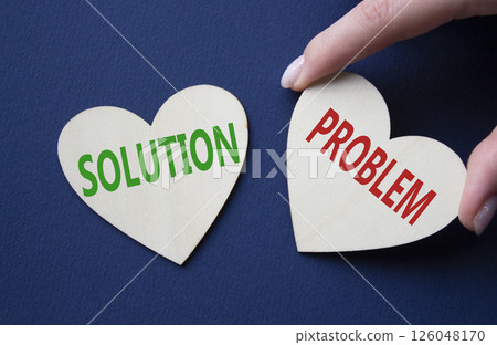 Solution vs Problem symbol. Concept word Solution vs Problem on wooden hearts. Businessman hand. Beautiful deep blue background. Business and Solution vs Problem concept. Copy space 126048170