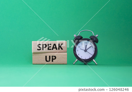 Speak Up symbol. Wooden blocks with words Speak Up Beautiful green background with alarm clock. Business and Speak Up concept. Copy space. Speak Up symbol. Wooden blocks with words Speak Up Beautiful green background with alarm clock. Business and Speak Up concept. Copy space. 126048246