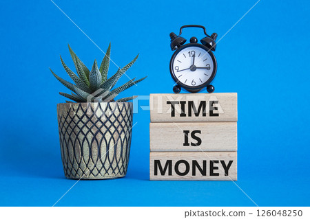 Time is Money symbol. Concept words Time is Money on wooden blocks. Beautiful blue background with alarm clock and succulent plant. Business and Time is Money concept. Copy space 126048250