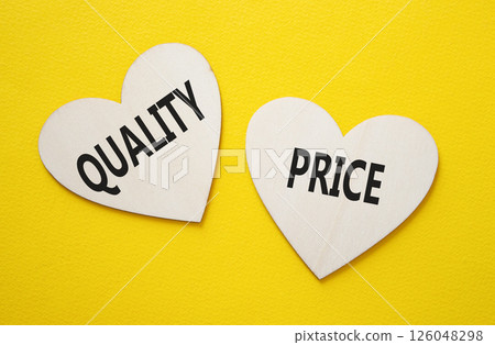 Price or Quality symbol. Concept word Price or Quality on wooden hearts. Beautiful yellow background. Business and Price or Quality concept. Copy space 126048298