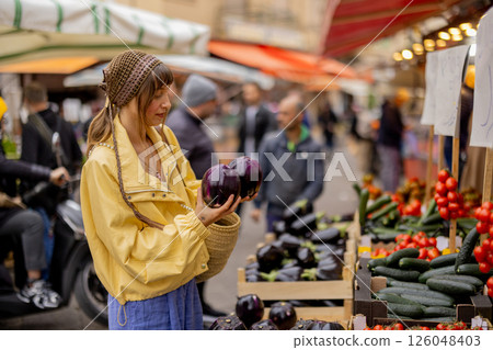 Choosing vegetables at a Sicilian market Choosing vegetables at a Sicilian market 126048403