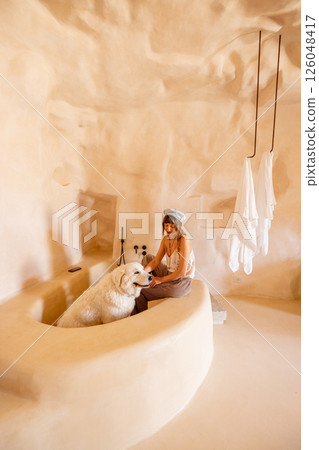Woman and white dog in sculpted clay bathtub, Sicily Woman and white dog in sculpted clay bathtub, Sicily 126048417
