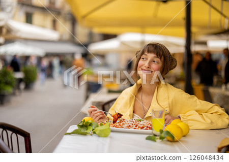 Happy woman enjoying Sicilian pasta Happy woman enjoying Sicilian pasta 126048434
