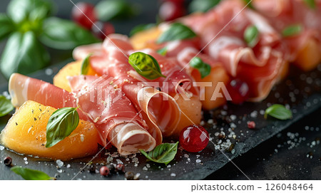 thin slices of prosciutto wrapped delicately around sweet cantaloupe and honeydew melon wedges thin slices of prosciutto wrapped delicately around sweet cantaloupe and honeydew melon wedges 126048464