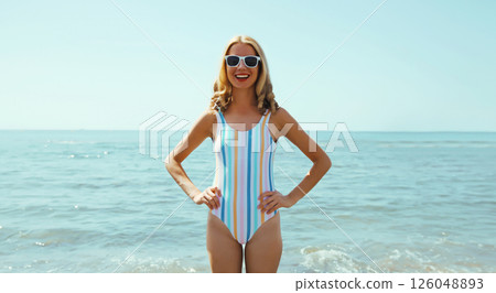 Summer vacation, beautiful happy slim cheerful woman in swimsuit having fun on the beach at sea 126048893
