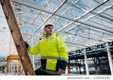 Construction workers at work on modern building site. 126049390