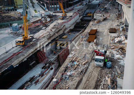 Builders working on structural development at an active construction site. 126049396