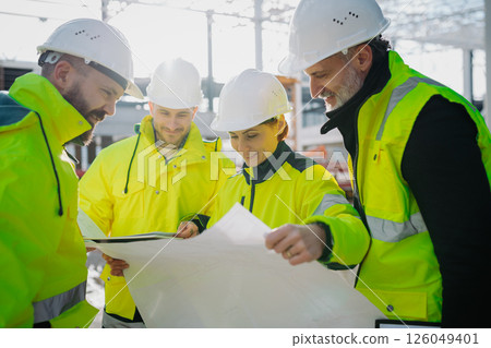 Team of engineers and construction workers inspecting building progress. 126049401