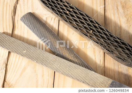 Close up of a Set of Rasps lying on wooden planks in a carpentry workshop Close up of a Set of Rasps lying on wooden planks in a carpentry workshop 126049834