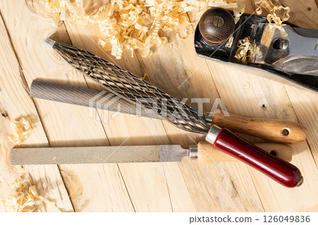 Flat lay of s Set of Rasps lying on wooden planks in a carpentry workshop 126049836