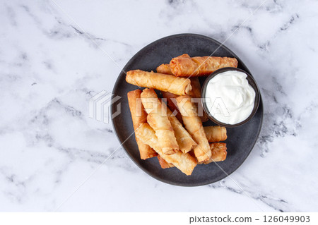 fried spring rolls with cheese, on a plate, with cream sauce, no people, 126049903