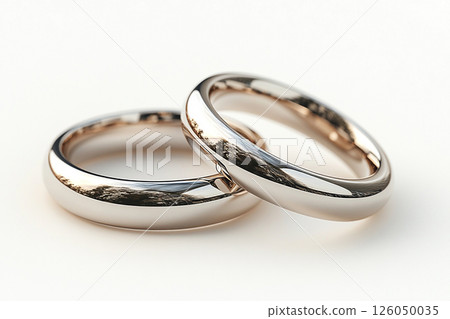 Pair of white gold wedding rings on a white background. Pair of white gold wedding rings on a white background. 126050035
