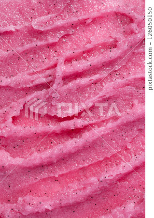 Texture of pink strawberry scrub. Fruit exfoliation scrubber for body and face in SPA. Body care scrub background for design. 126050150
